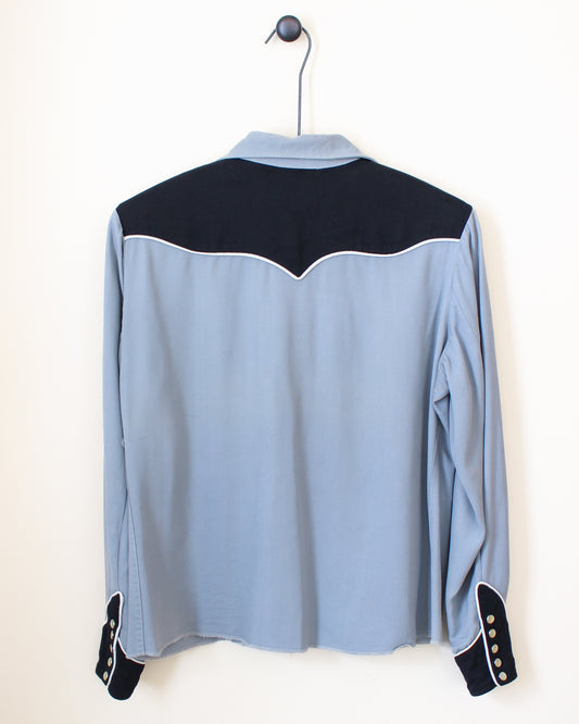 Light blue shirt with black accents on a hanger against a white background