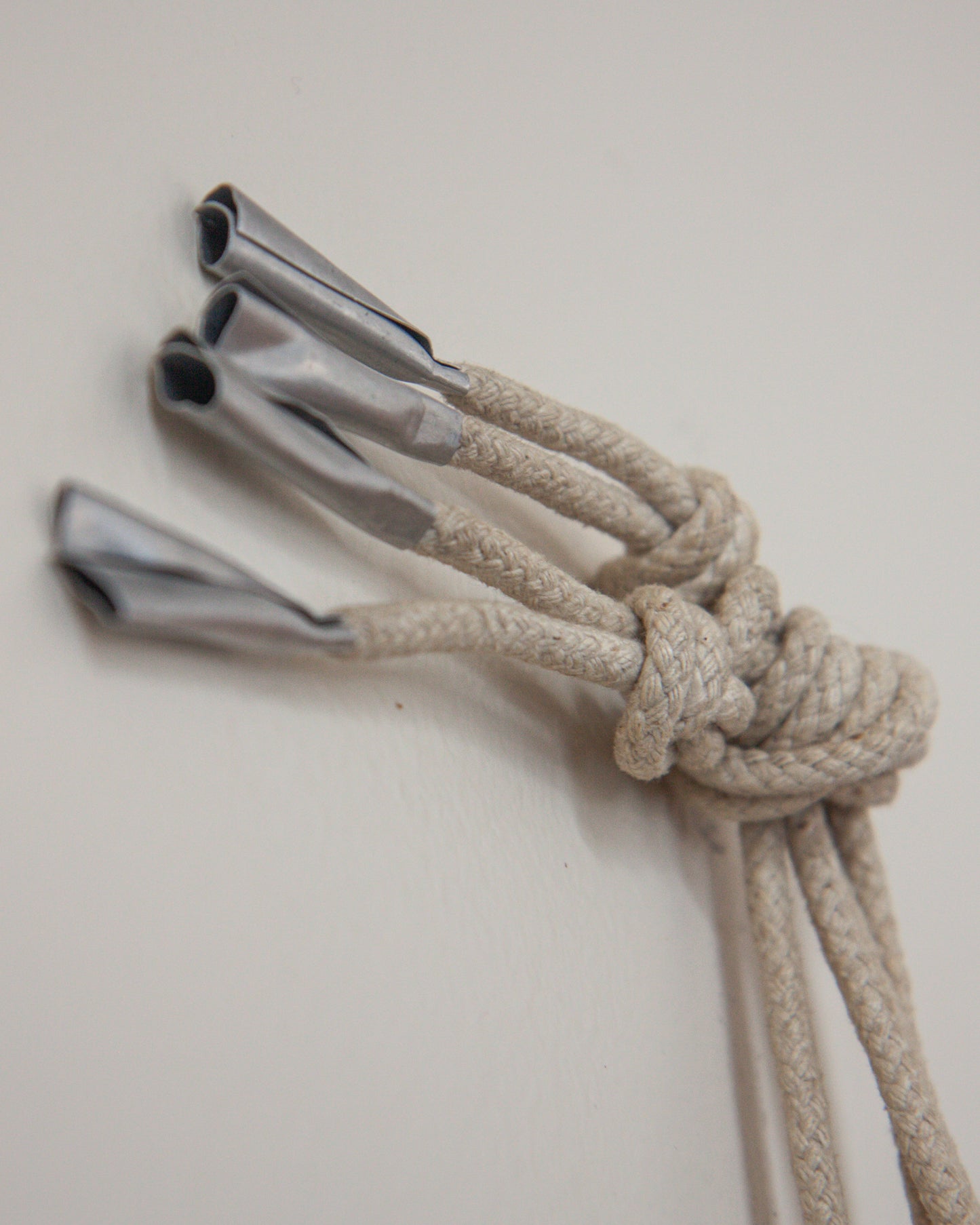 Nautical rope with metal clips on a light gray background