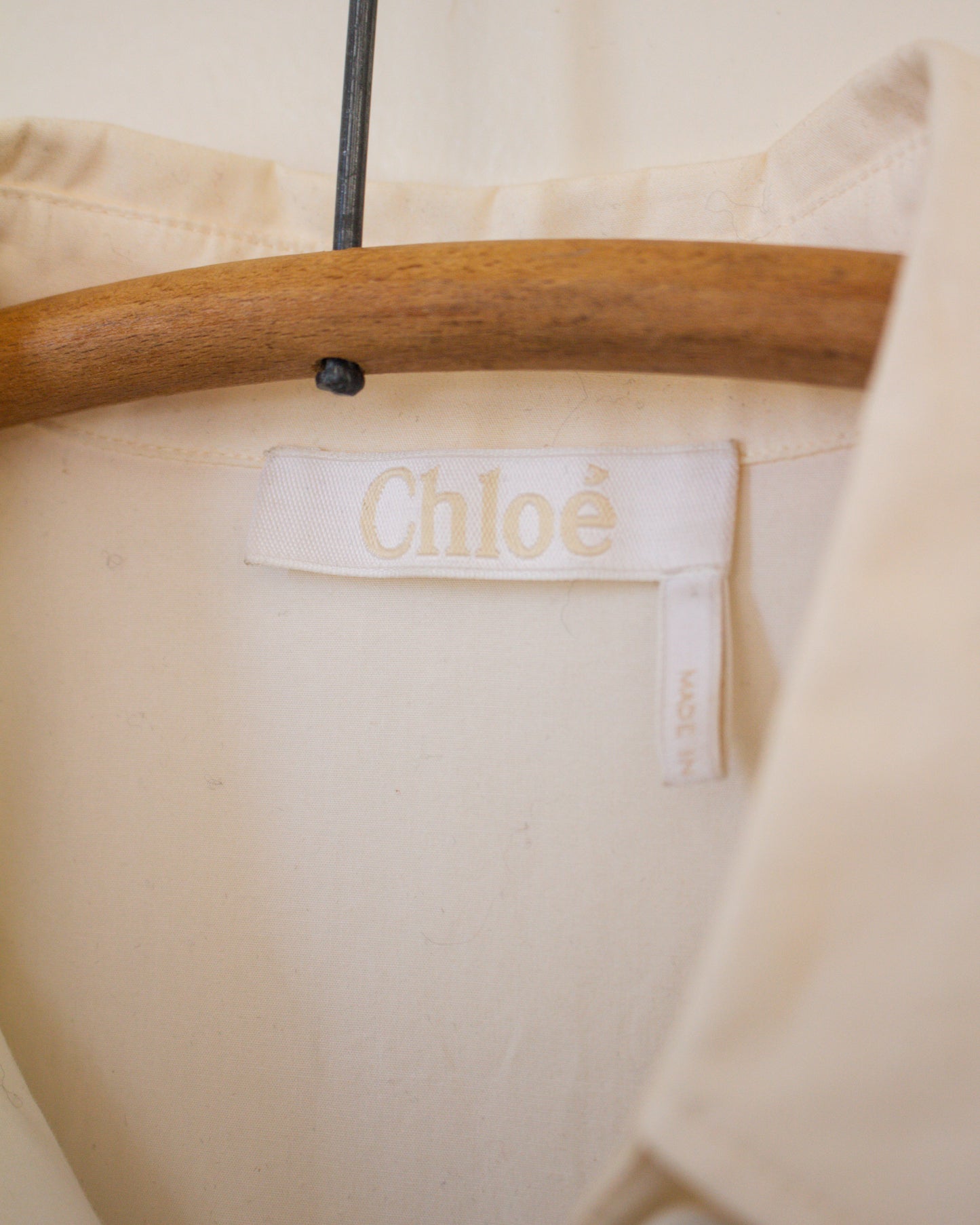 White blouse garment with Chloe label on a hanger