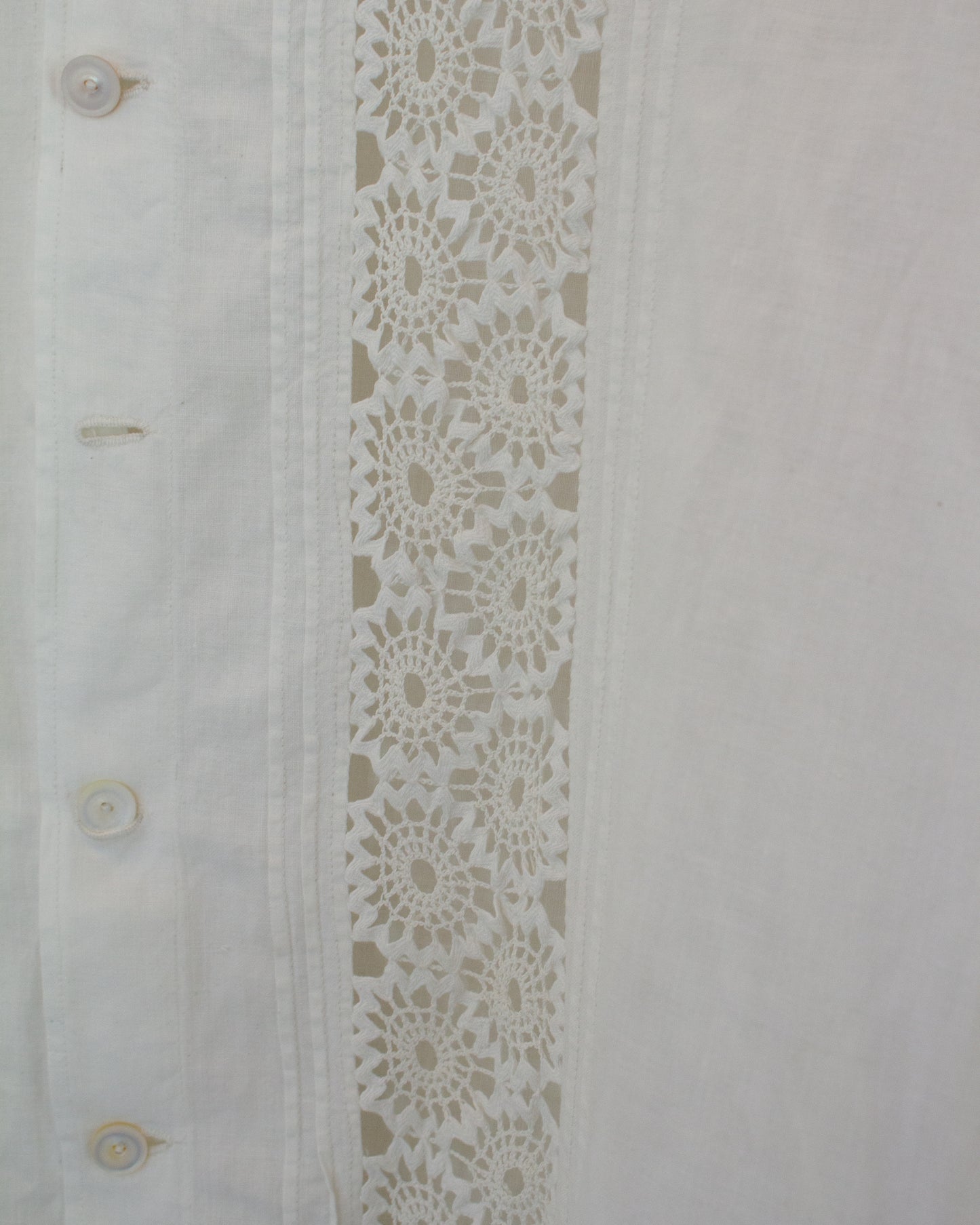 Close up of white dress with lace detailing