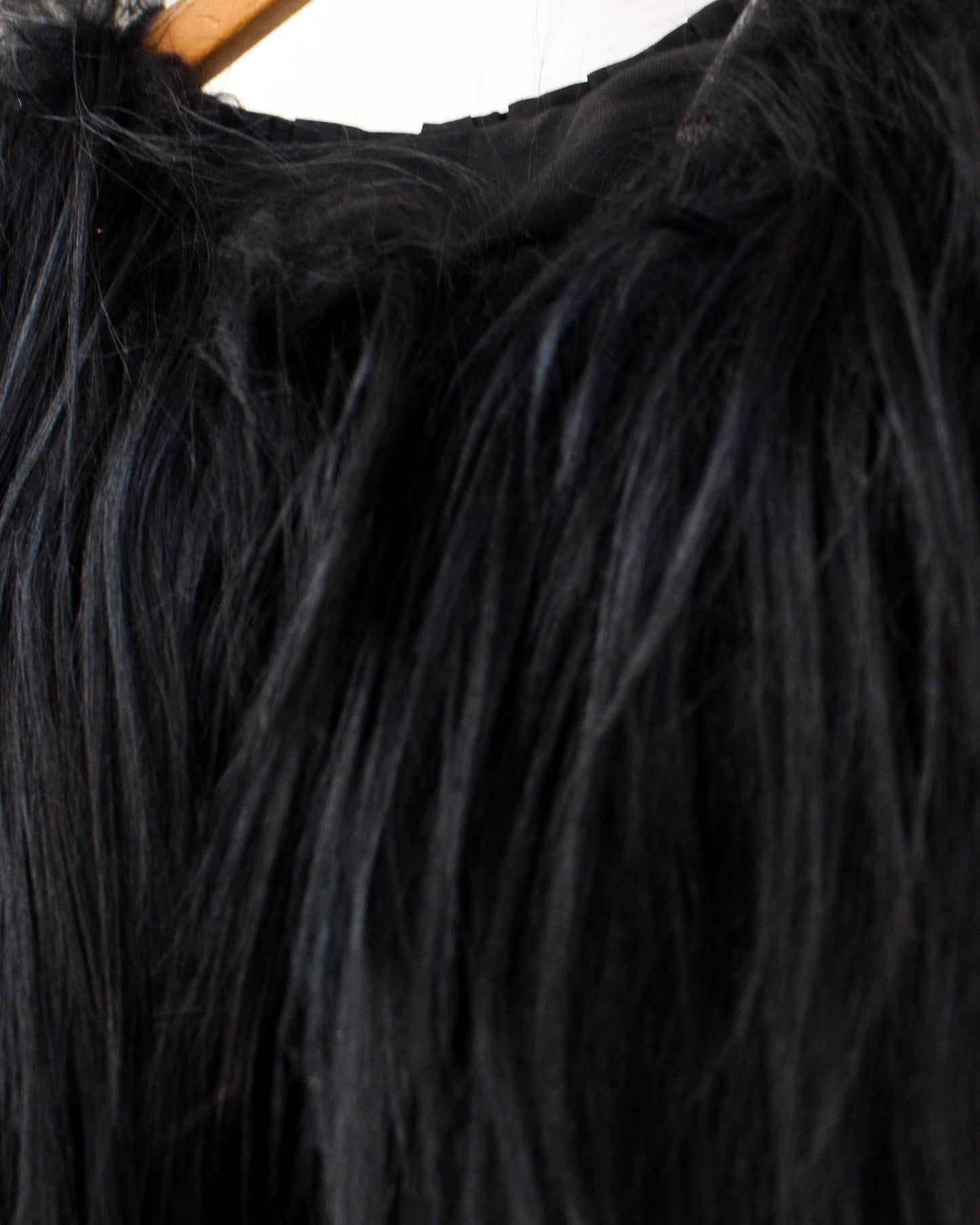 Close-up of black fur with a wooden handle