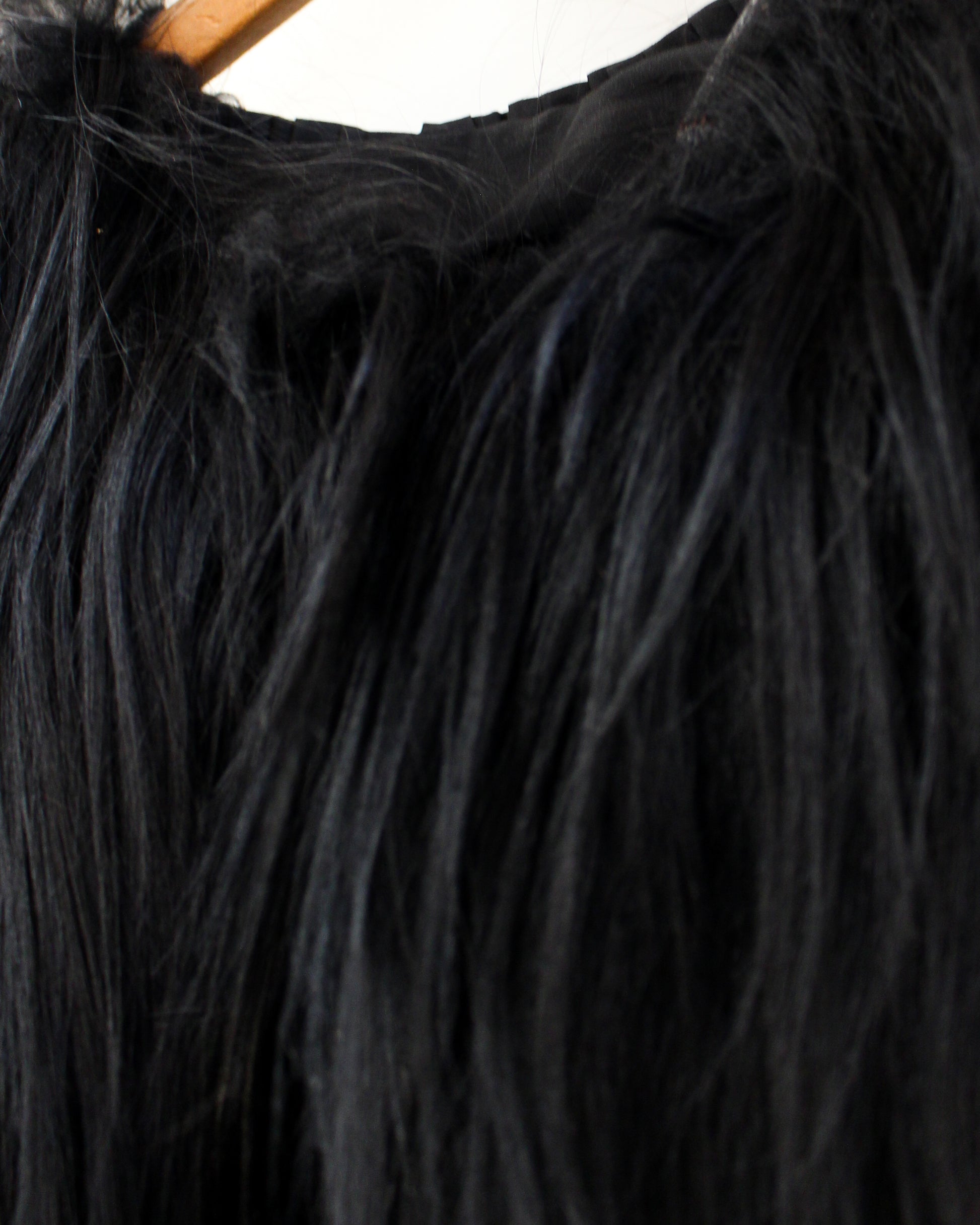 Close-up of black fur with a wooden handle