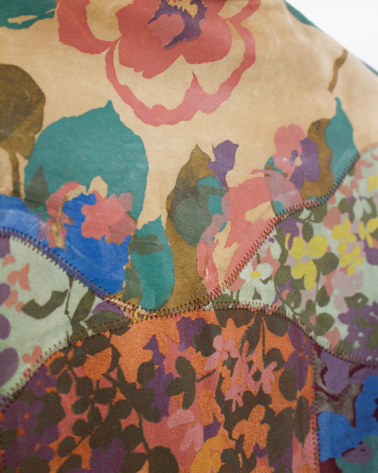 Close-up of a colorful patchwork fabric with floral patterns.