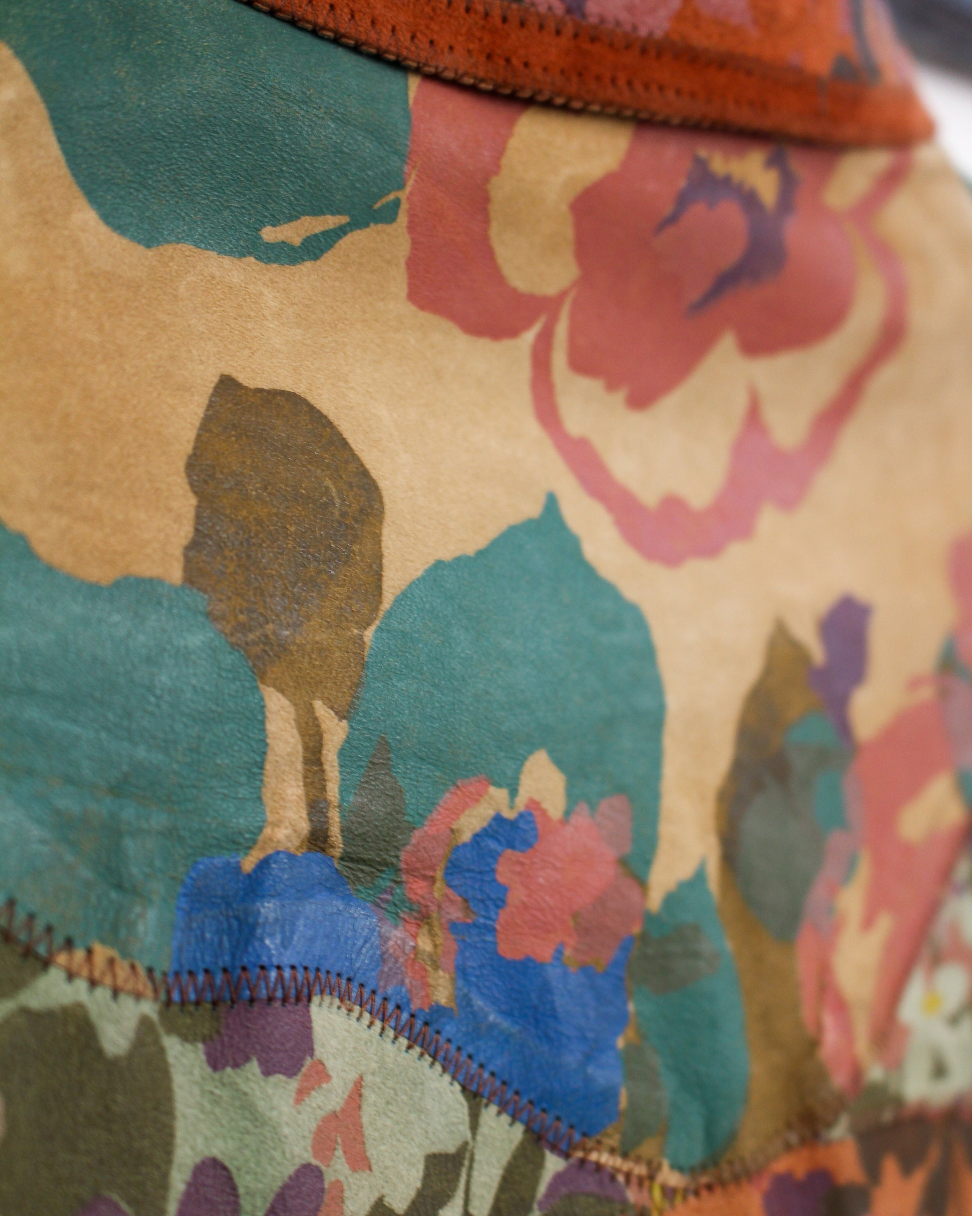 Close-up of a colorful fabric with abstract designs and a zipper.