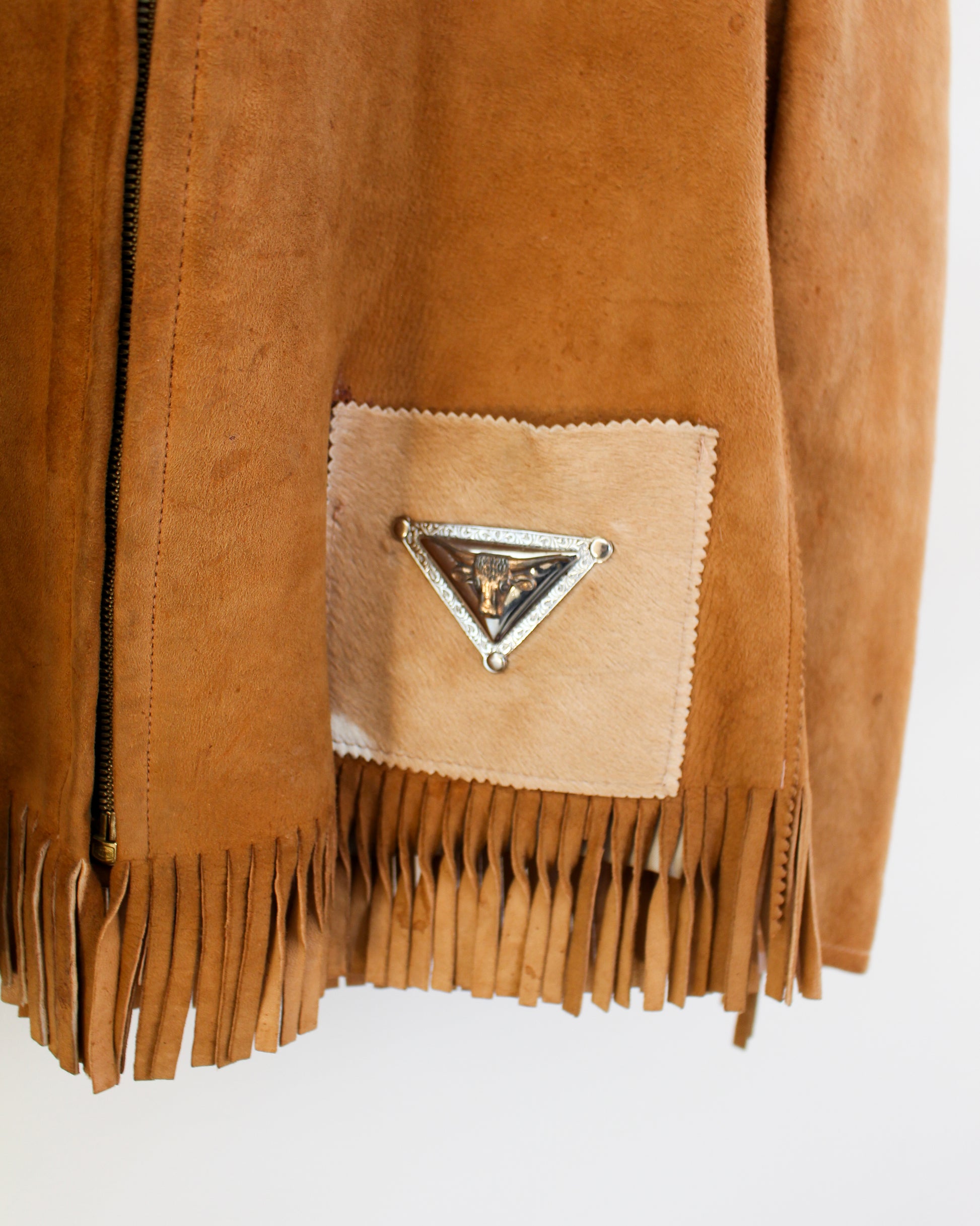 Close up of metal longhorn accent on jacket pocket