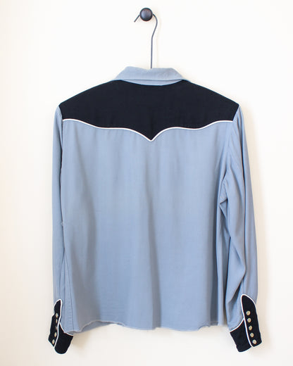 Light blue shirt with black accents on a hanger against a white background