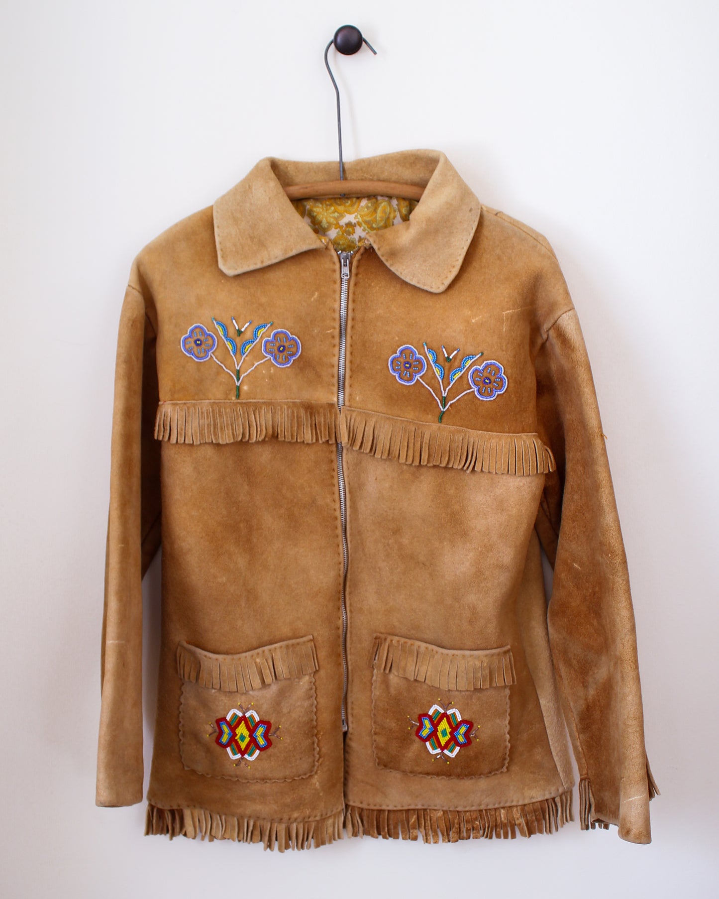Brown suede jacket with colorful embroidery and fringes on a white background