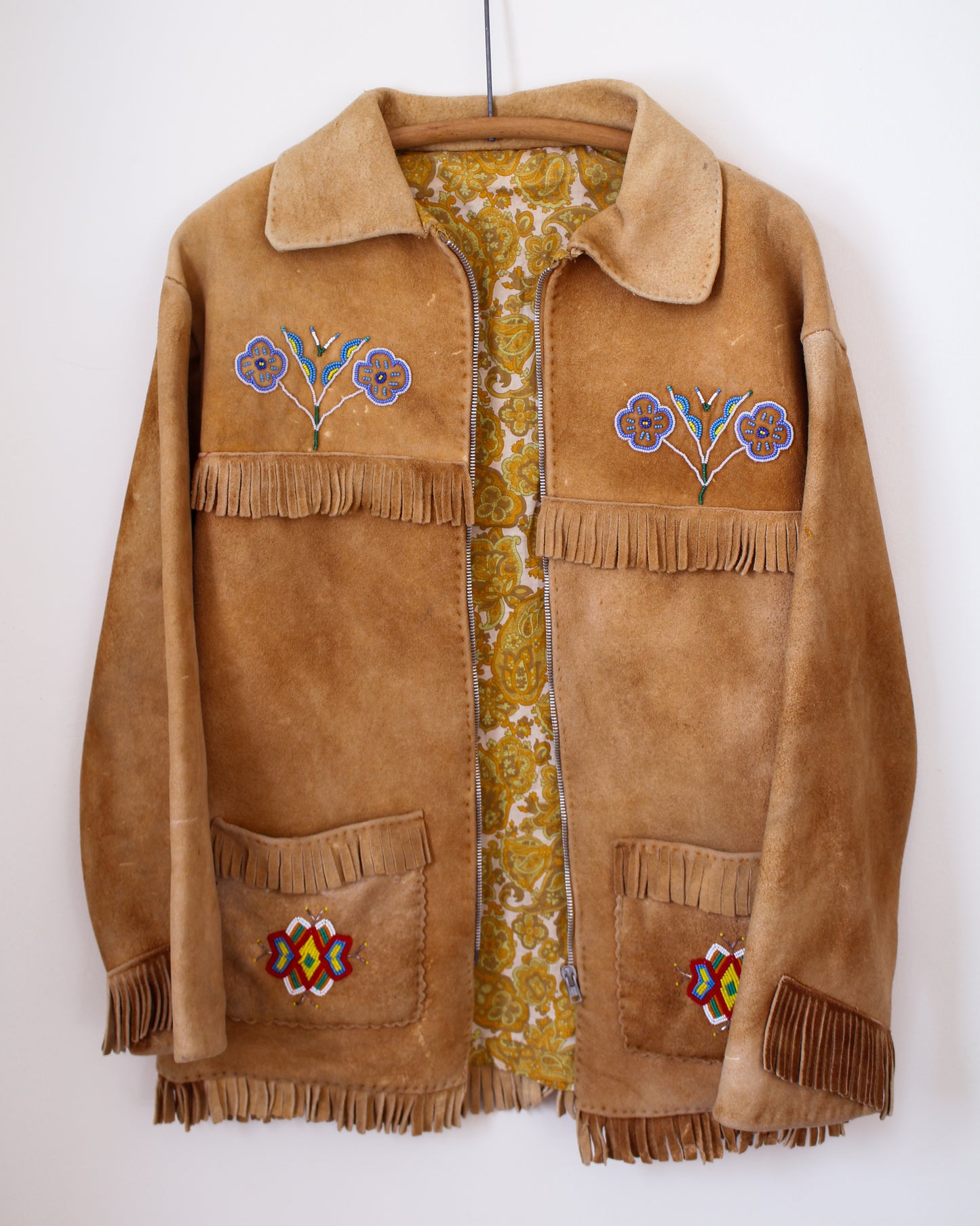 Brown suede jacket with floral embroidery and fringes on a white background