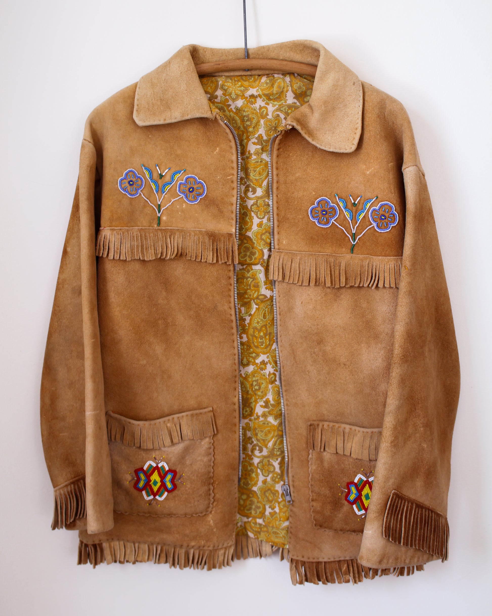 Brown suede jacket with floral embroidery and fringes on a white background