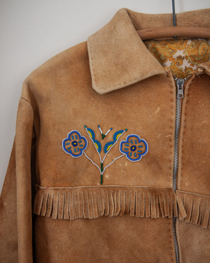 Brown suede jacket with floral embroidery and fringes on a plain background