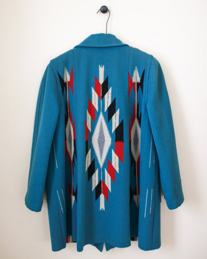 Blue coat with geometric pattern on a white background