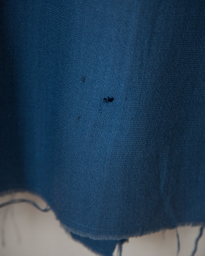 Close-up of a blue fabric with a small black mark