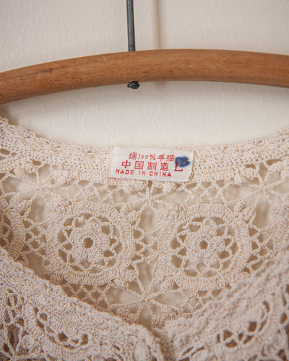 Lace fabric on a wooden hanger with a 'Made in China' label.