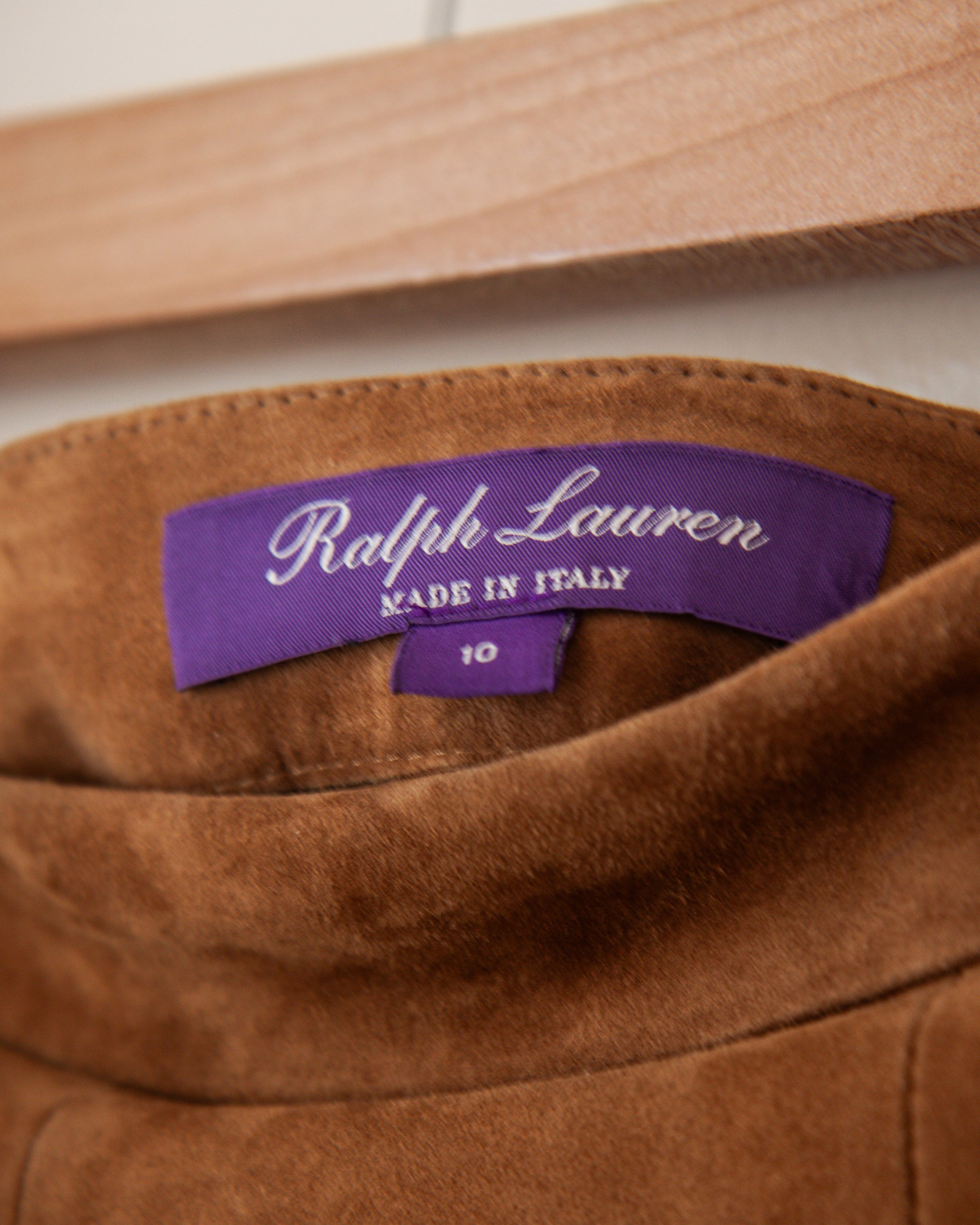 Brown suede jacket with Ralph Lauren label on a wooden hanger