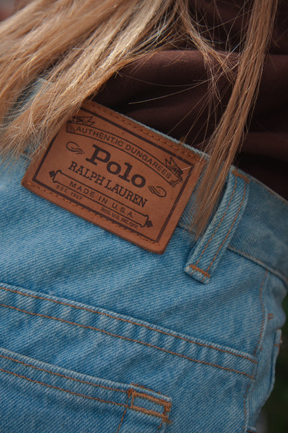 Close-up of a Polo Ralph Lauren label on blue denim skirt.