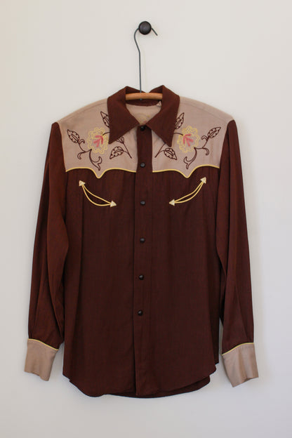 Brown shirt with embroidered details on a white background