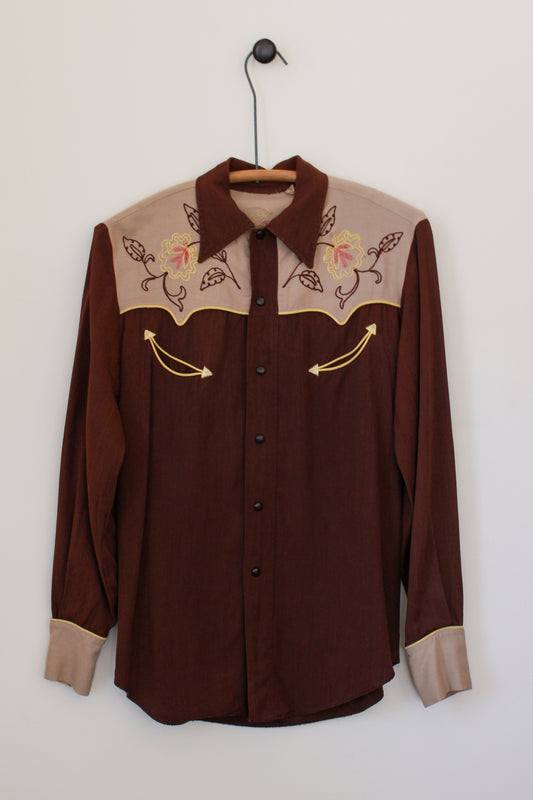 Brown shirt with embroidered details on a white background