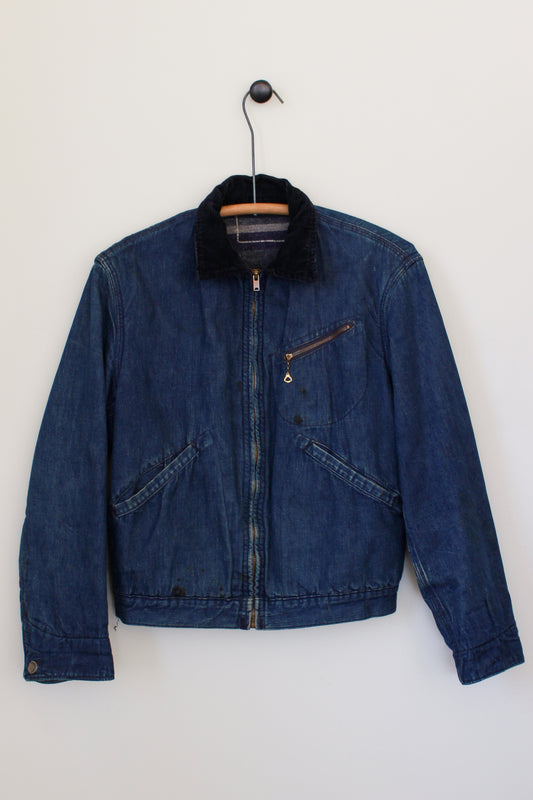 Blue denim jacket on a hanger against a white background