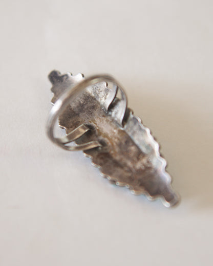 back of sterling silver ring on a light gray background