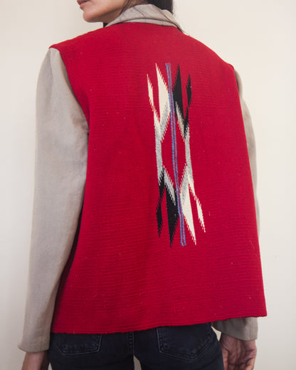 Red jacket with a geometric pattern on the back, worn by a person against a plain background