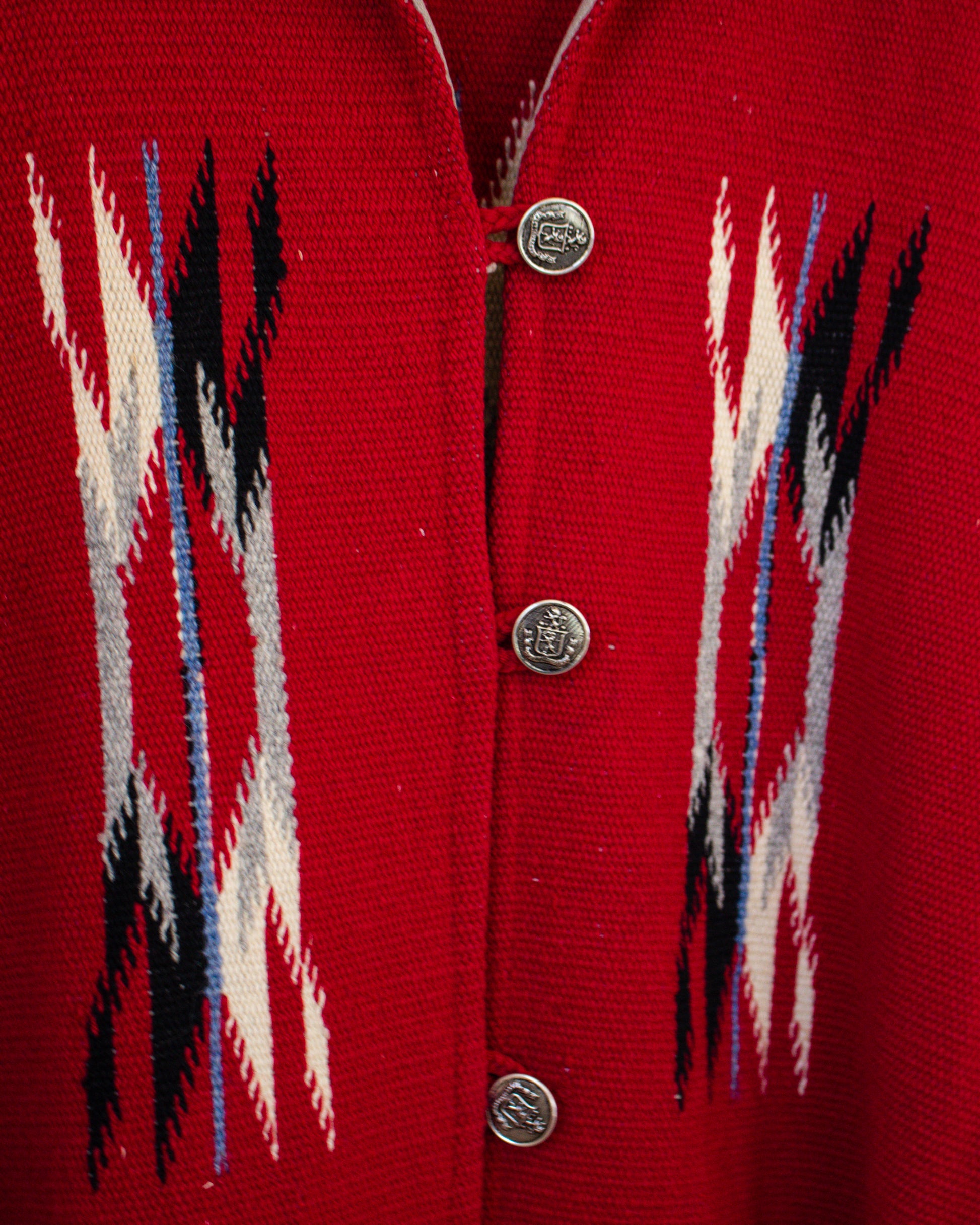 Red cardigan with patterned front and visible buttons