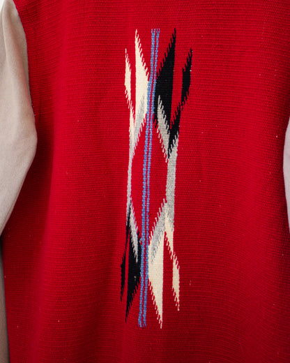 Red jacket with a geometric pattern featuring black, white, and blue lines.