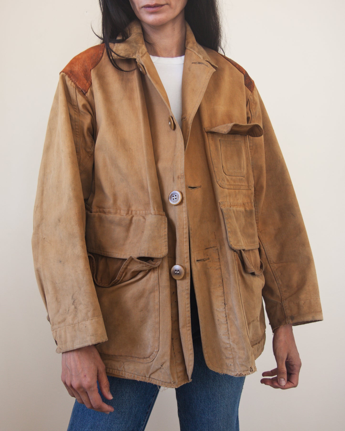 Person wearing a brown jacket with a white background