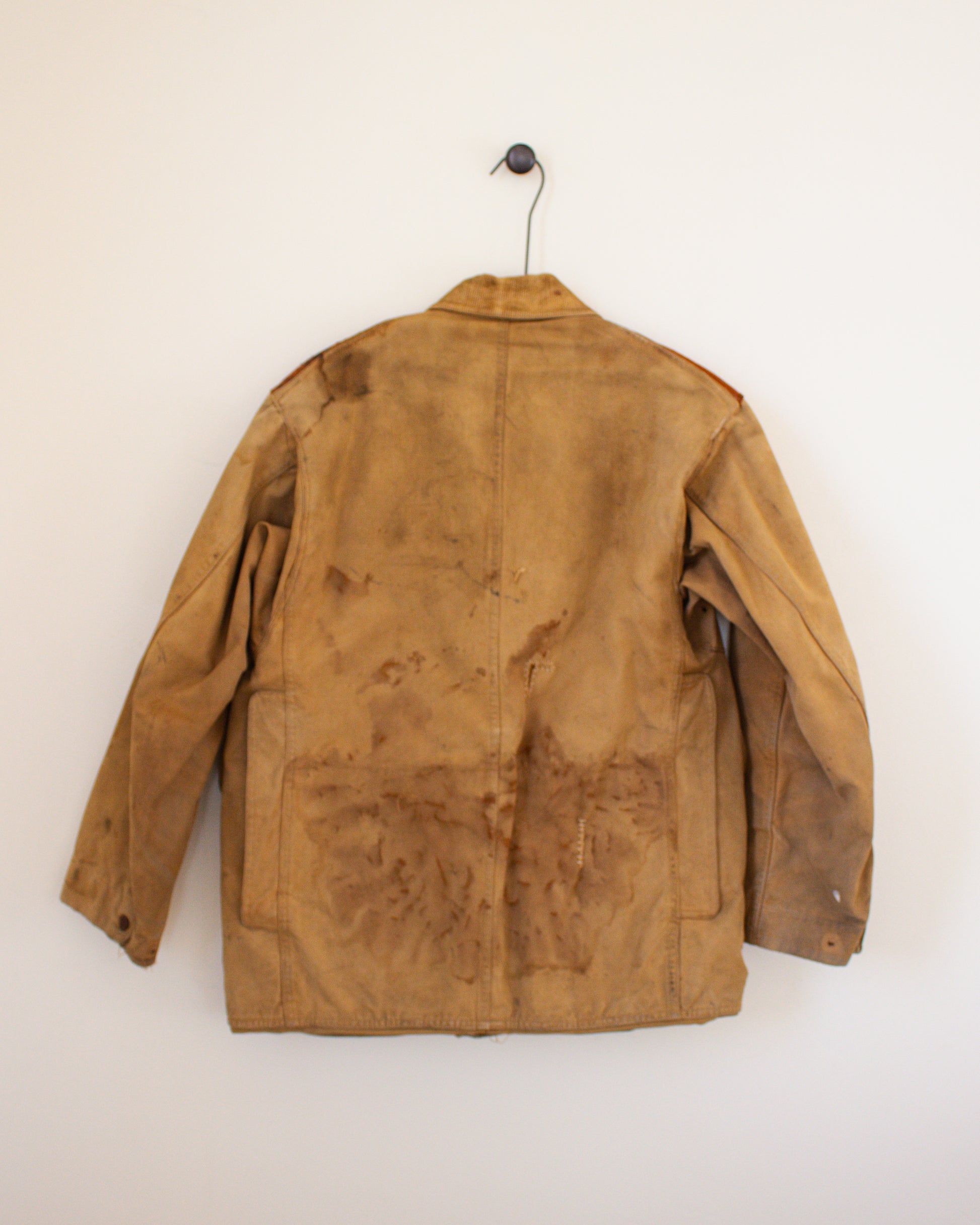 Brown canvas jacket with visible wear on a white background