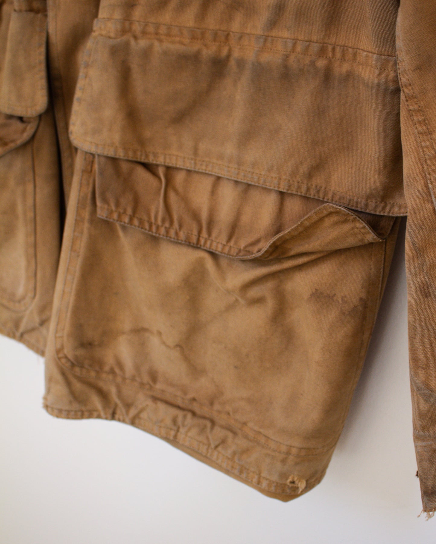 Brown jacket with multiple pockets on a white background