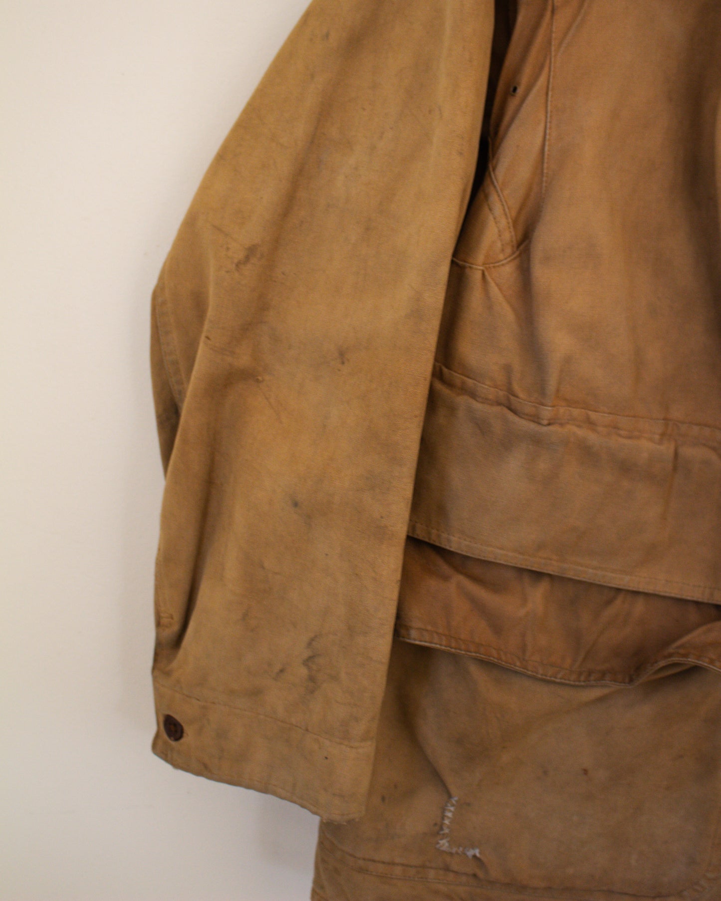 Close up of sleeve flaw on brown jacket