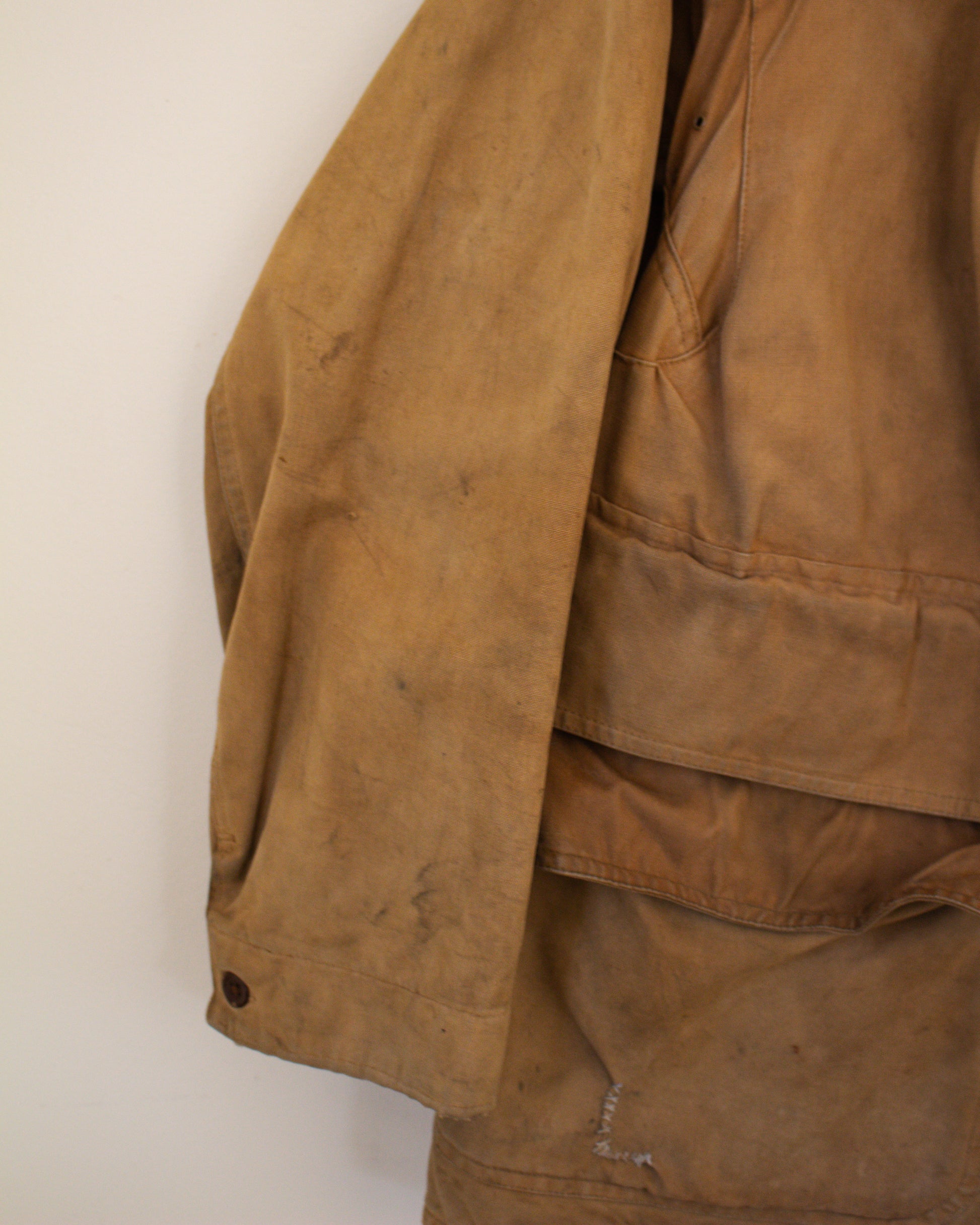 Close up of sleeve flaw on brown jacket