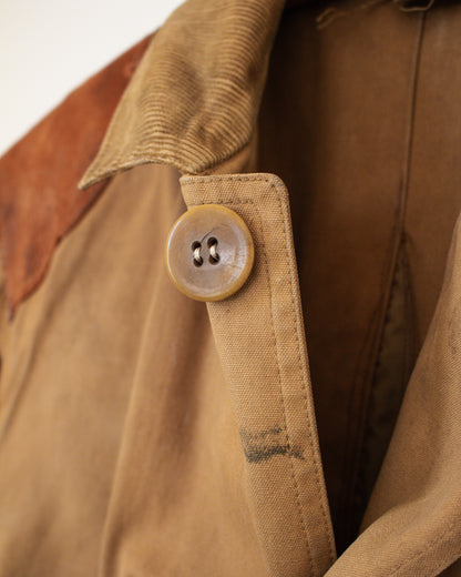 Close-up of a brown canvas jacket with a button