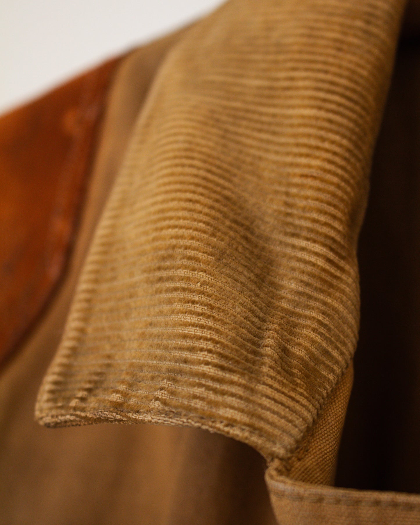 Close-up of brown corduroy fabric with a blurred background