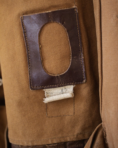 Close-up of a brown fabric patch with a rectangular cutout inside jacket