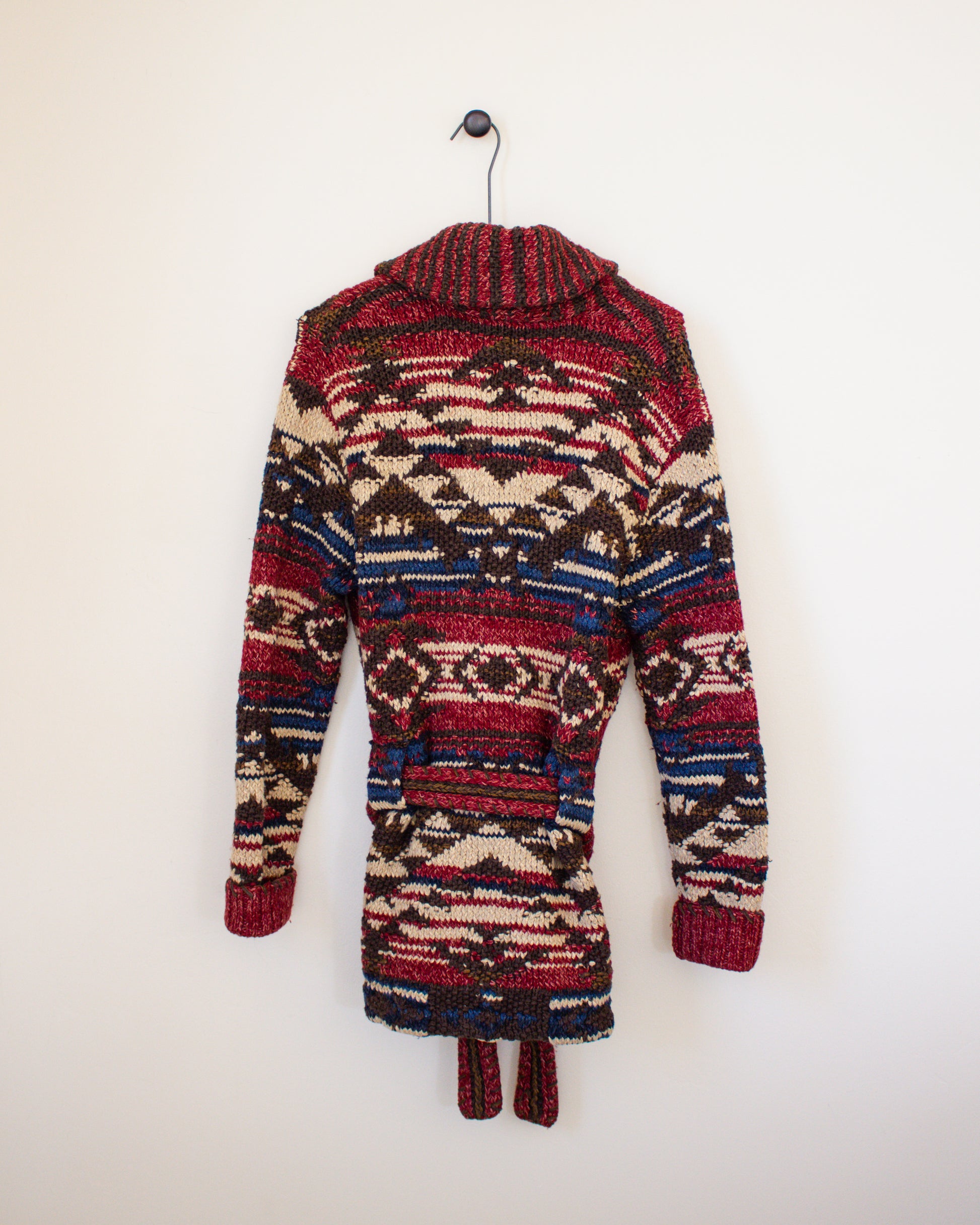 Colorful patterned jacket on a hanger against a white background - back view