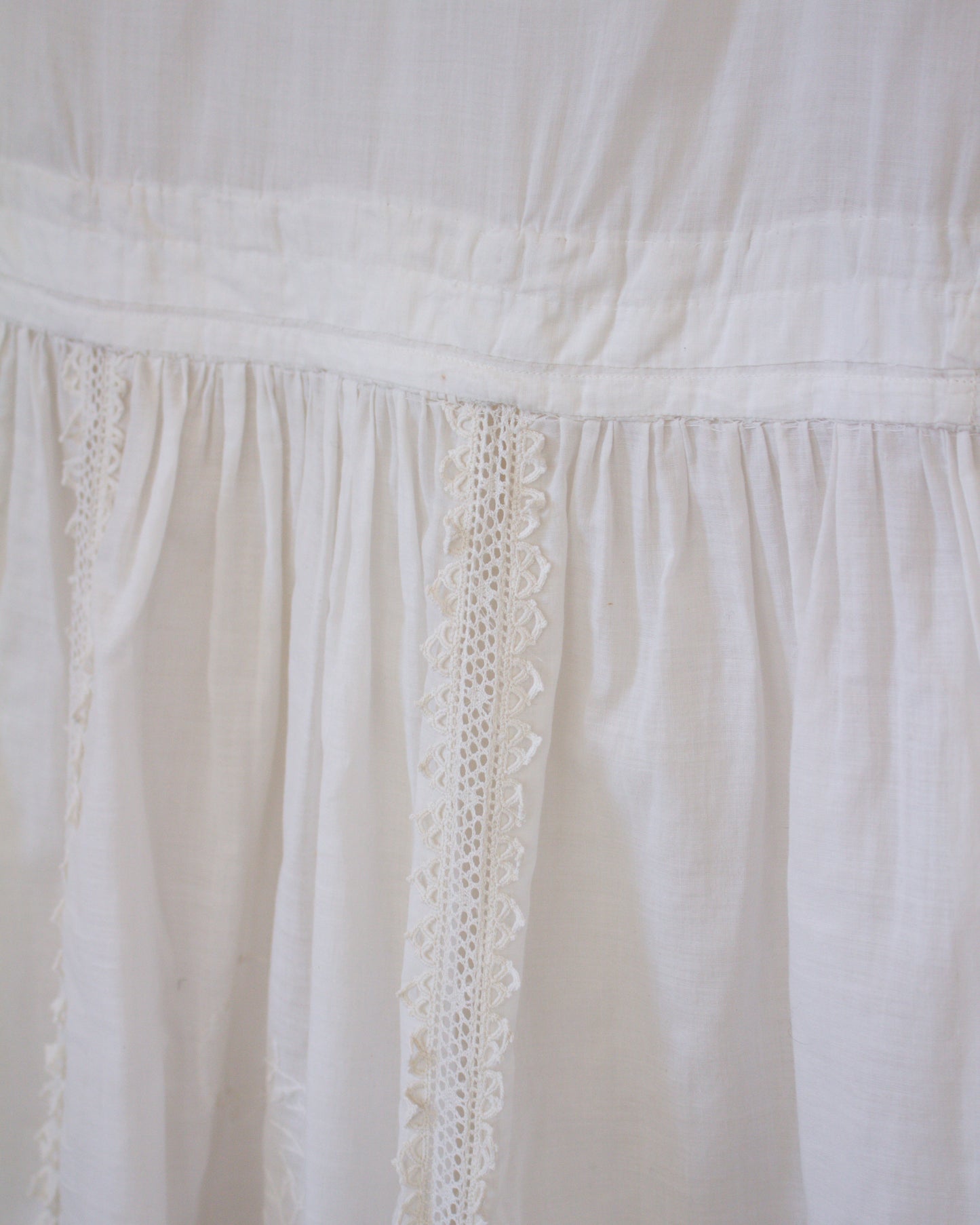 Close-up of a white fabric with lace detailing