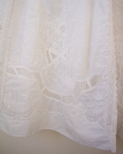Close-up of a white lace fabric with intricate patterns