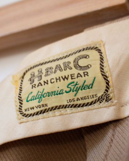Close-up of a label on a piece of beige fabric with 'HBarC Ranchwear' branding.