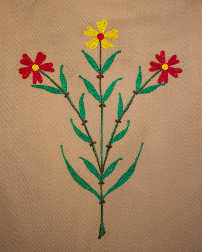 Embroidered design of flowers on a beige vest