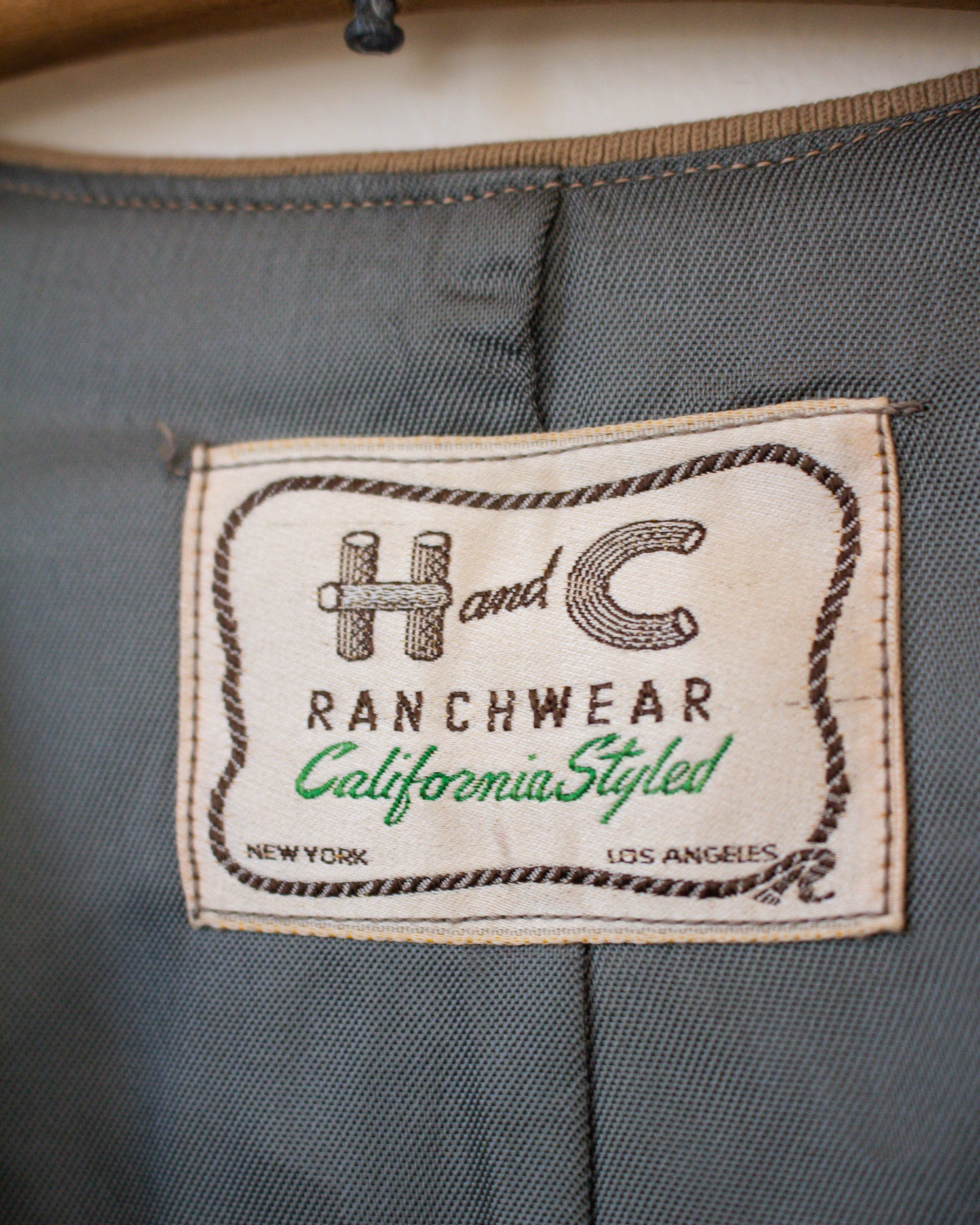 Label on a gray fabric with 'H & C Ranchwear' branding