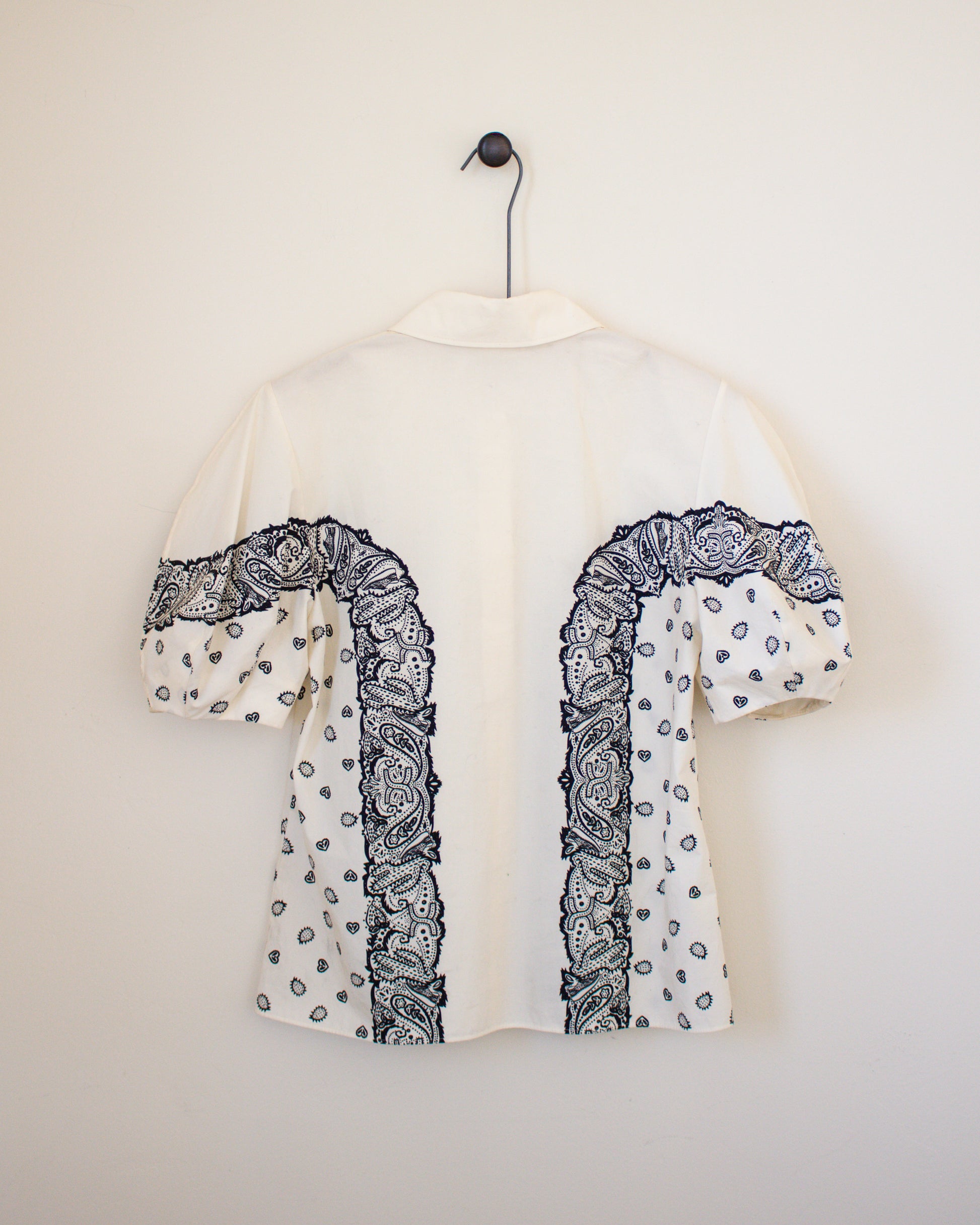 White blouse with black bandana patterns on a white background