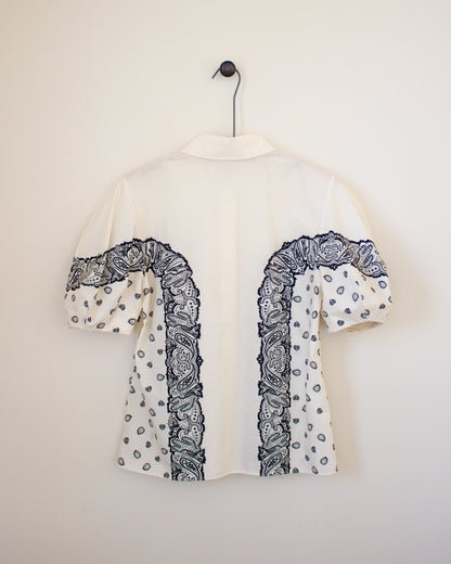 White blouse with black bandana patterns on a white background