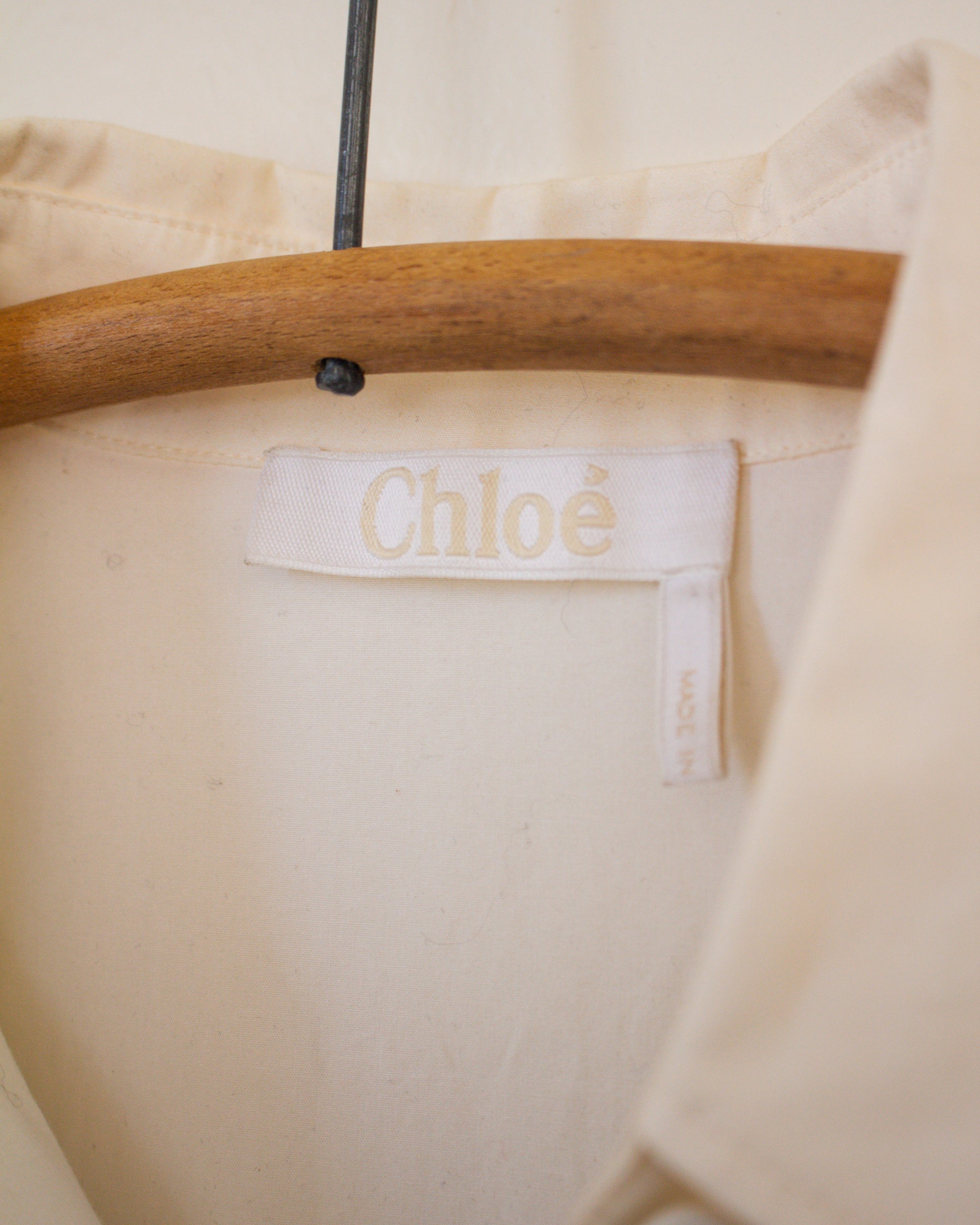 White blouse garment with Chloe label on a hanger