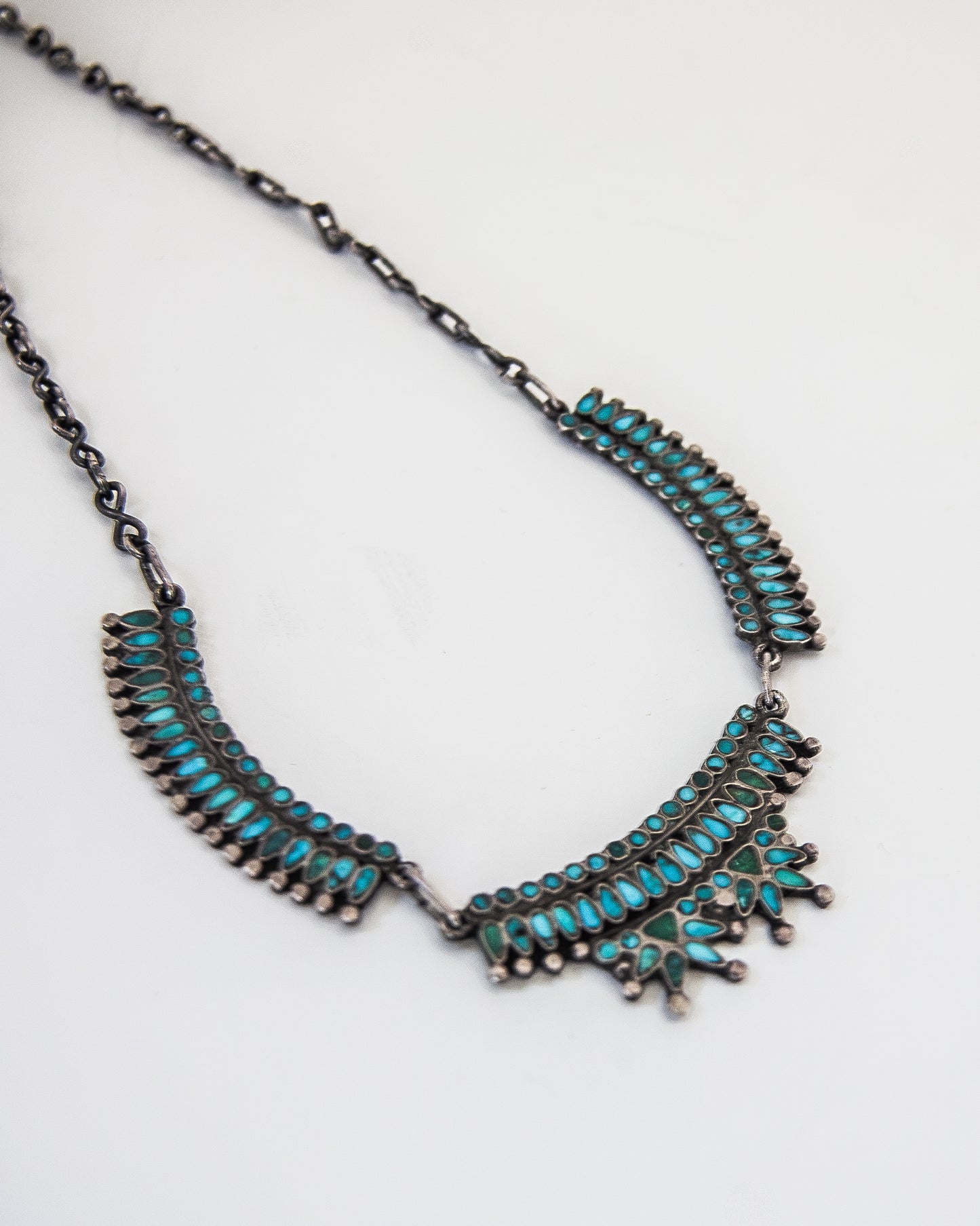Turquoise inlay necklace on a silver chain.