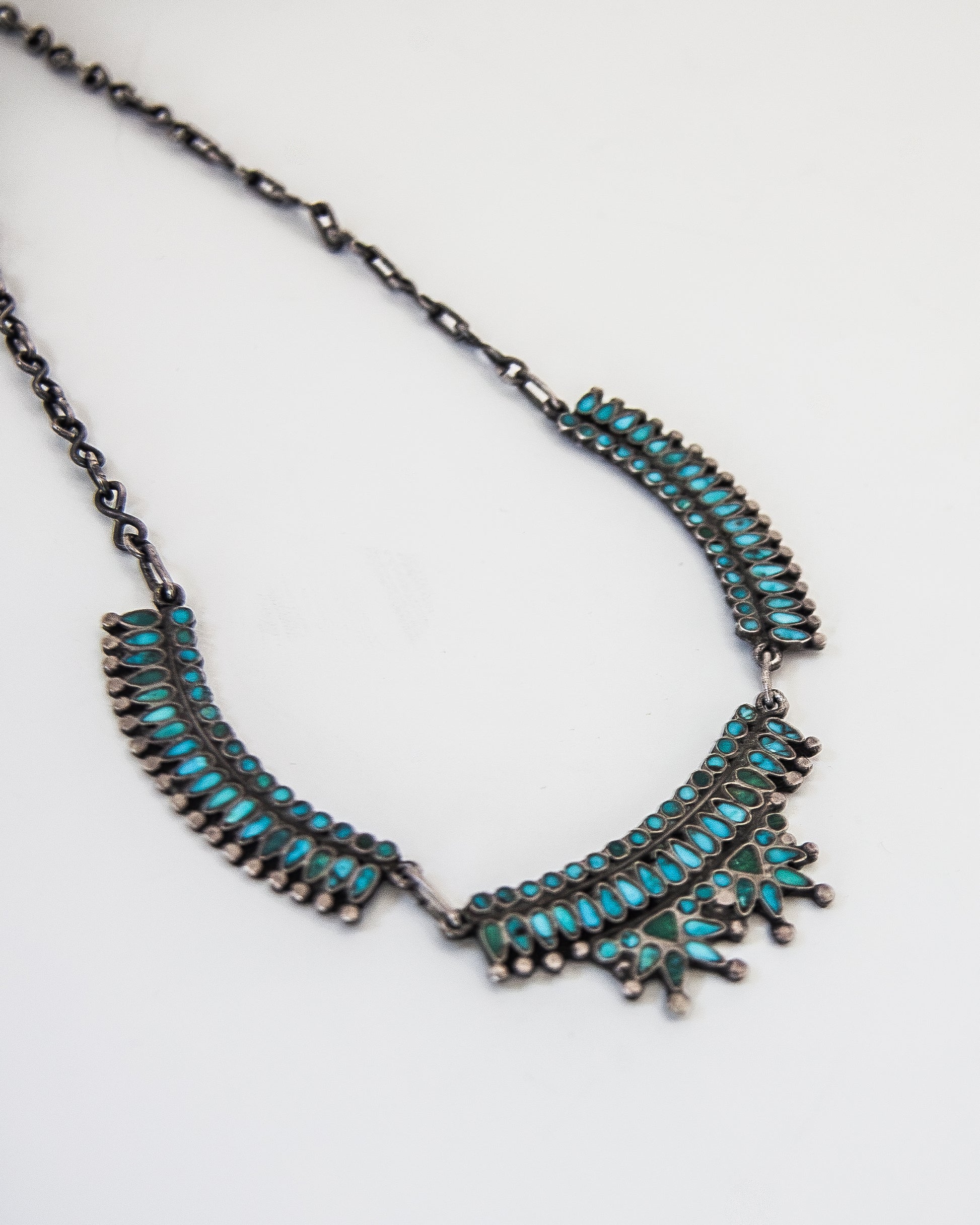 Turquoise inlay necklace on a silver chain.