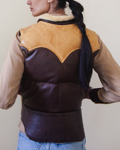 Back of woman wearing down leather vest with hands in pockets
