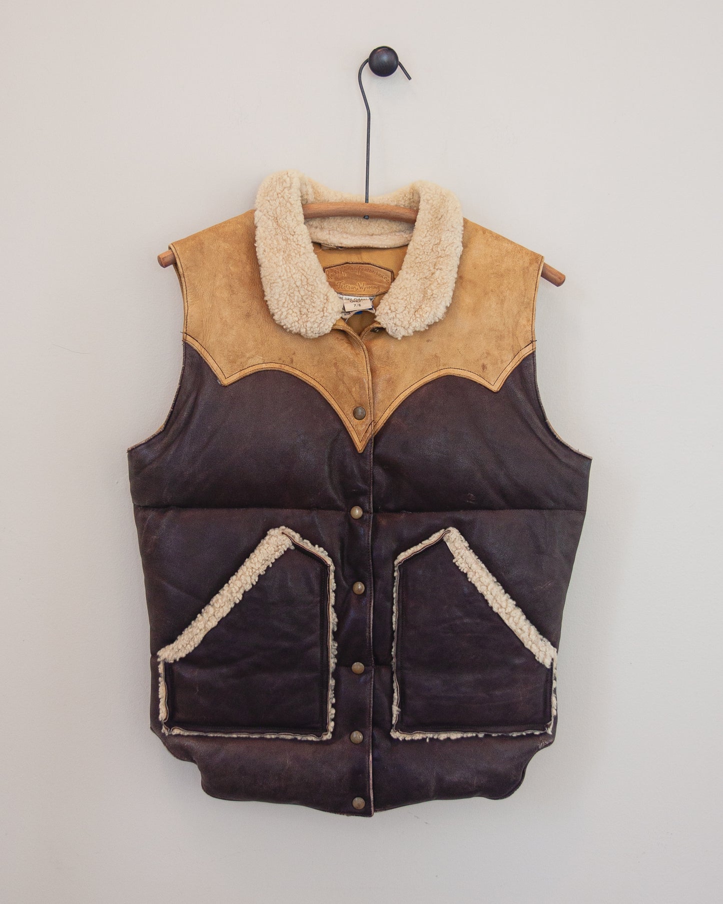 Down leather vest on a hanger