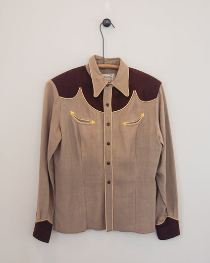 Front of tan and brown Western shirt with smile pockets on a hanger