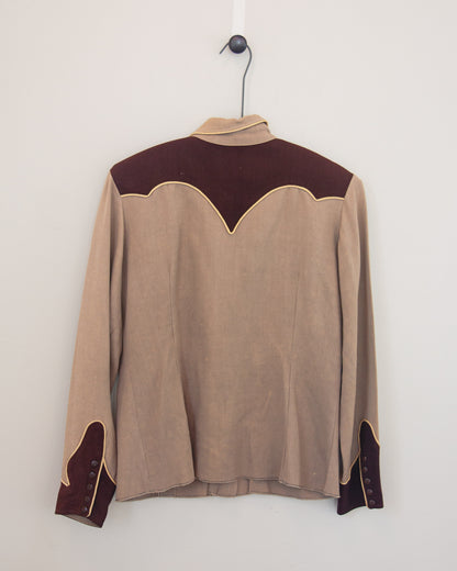 Back of tan and brown Western shirt with smile pockets on a hanger