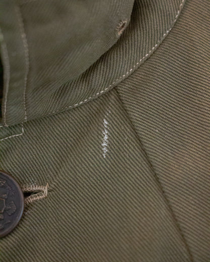White mark on green jacket